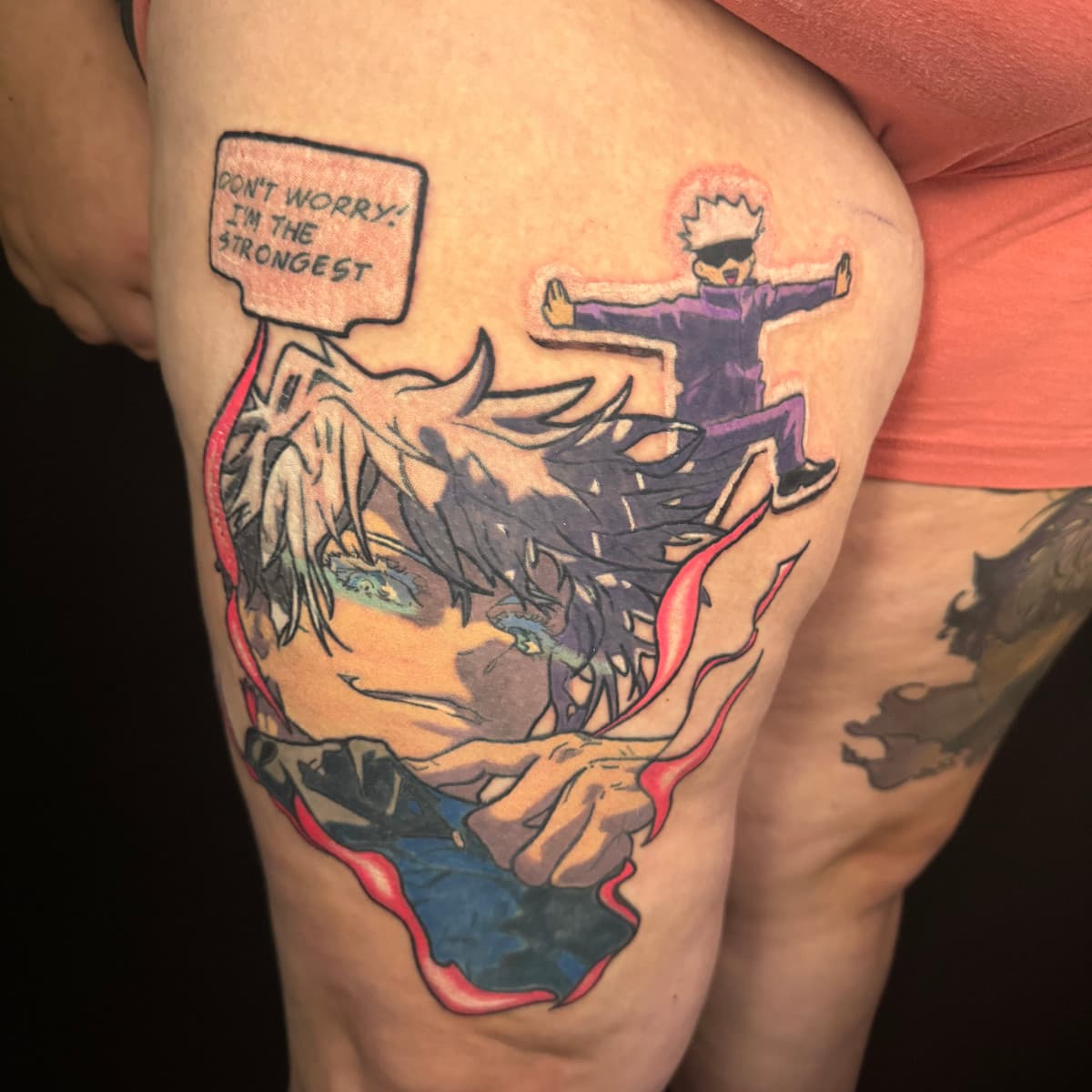 Jujutsu Kaisen Gojo Satoru thigh tattoo with red ribbons, paired with a chibi Gojo and "Don't Worry I'm The Strongest" speech bubble.